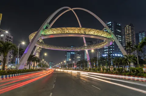 The ring of the Biswa Bangla Gate lit over the main road of New Town, Kolkata