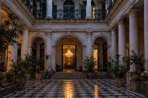 The pillared courtyard of an old North Kolkata mansion at Sobha Bazar with a chandelier glowing inside